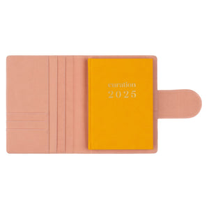 Compendium flamingo pink colour with Curation 2025 diary inside