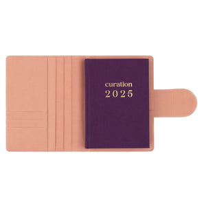 Compendium flamingo pink colour with Curation 2025 diary inside